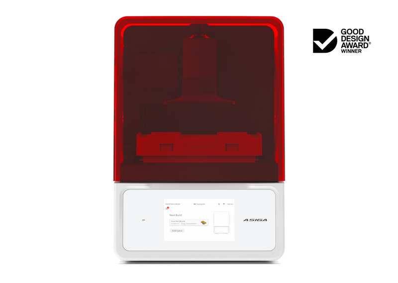 A front view of the Asiga Max 2 3D printer featuring a translucent red top hood, closed, with a filtered view of the build plate and material tray, and a white lower control panel featuring a touchscreen interface, shown on a solid white background with a Good Design Award 2024 badge in the top right corner.