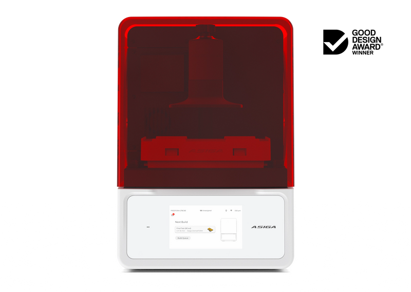 A front view of the Asiga Max 2 3D printer featuring a translucent red top hood, closed, with a filtered view of the build plate and material tray, and a white lower control panel featuring a touchscreen interface, shown on a solid white background with a Good Design Award 2024 badge in the top right corner.