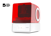 An offset right front view of the Asiga Max 2 3D printer featuring a translucent red top hood, closed, and a white lower control panel featuring a touchscreen interface, shown on a solid white background with a Good Design Award 2024 badge in the top right corner.