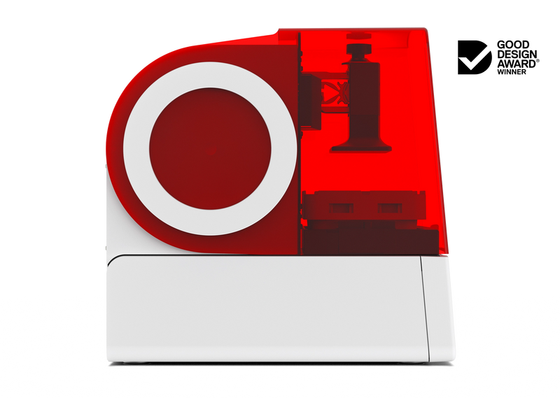 A left side view of the Asiga Max 2 3D printer featuring a fully closed translucent red top hood, showing the build plate and material tray view, shown on a solid white background with a Good Design Award 2024 badge in the top right corner.