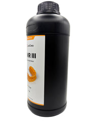 An offset view of a 1 kg black plastic bottle of LuxCreo DMR III Dental Model Resin, featuring an orange-colored resin tray printed on the front label, set against a plain white background.