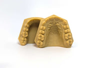 A pair of Ortho Px (printed with LuxCreo iLux at 100 µm) dental study models showing the upper and lower arches of a human dentition, photographed on a white background.
