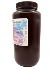 A dark brown plastic bottle with a ribbed screw cap of Ortho Px Pretty Pink, 1KG, showing the back of the label with text, a QR code, and colorful paint splatter graphics on a white background.