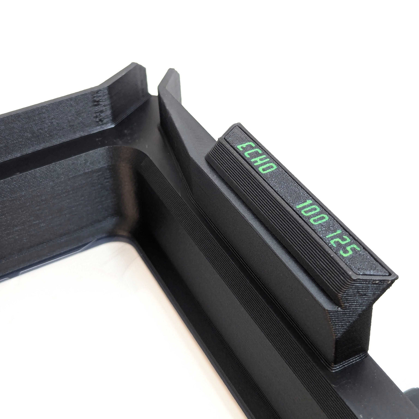 Close-up of Phoenix Echo Resin Tank with a small side label printed in green text reading 'ECHO 100 125' on a white background.