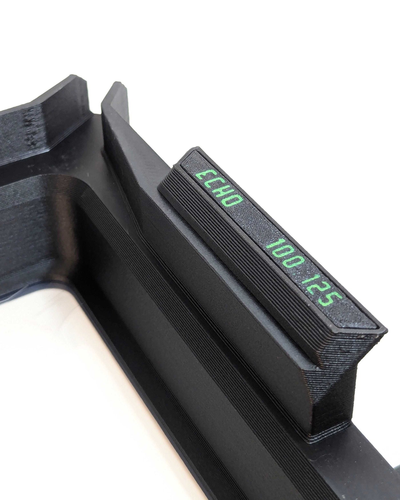 Close-up of Phoenix Echo Resin Tank with a small side label printed in green text reading 'ECHO 100 125' on a white background.